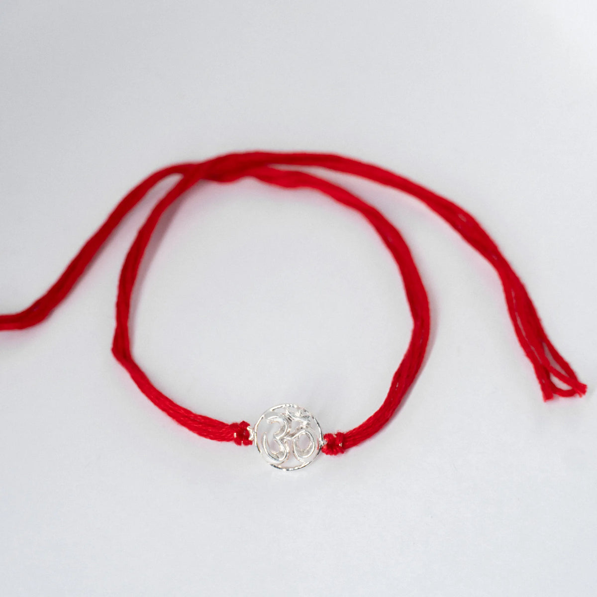 silver om rakhi