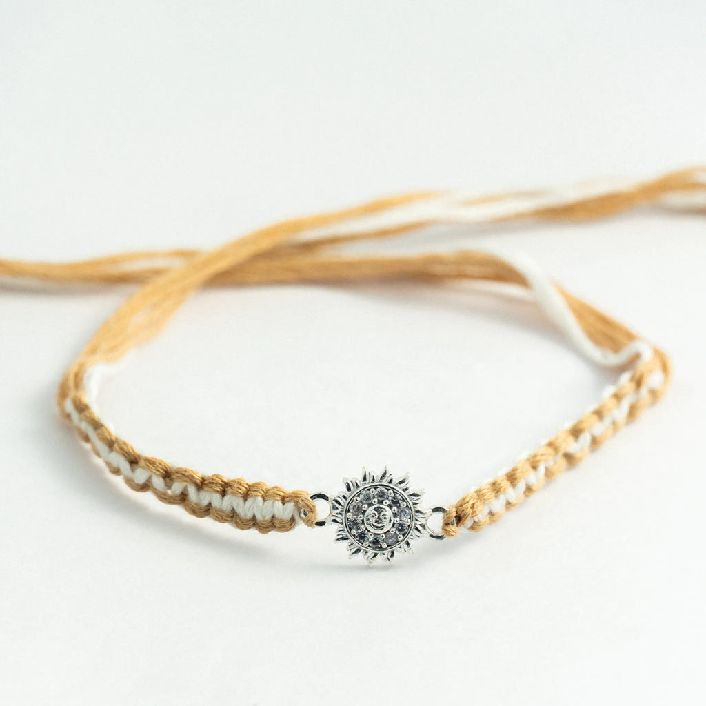 Silver Surya Rakhi for Brother with Handcrafted Beige and White Thread