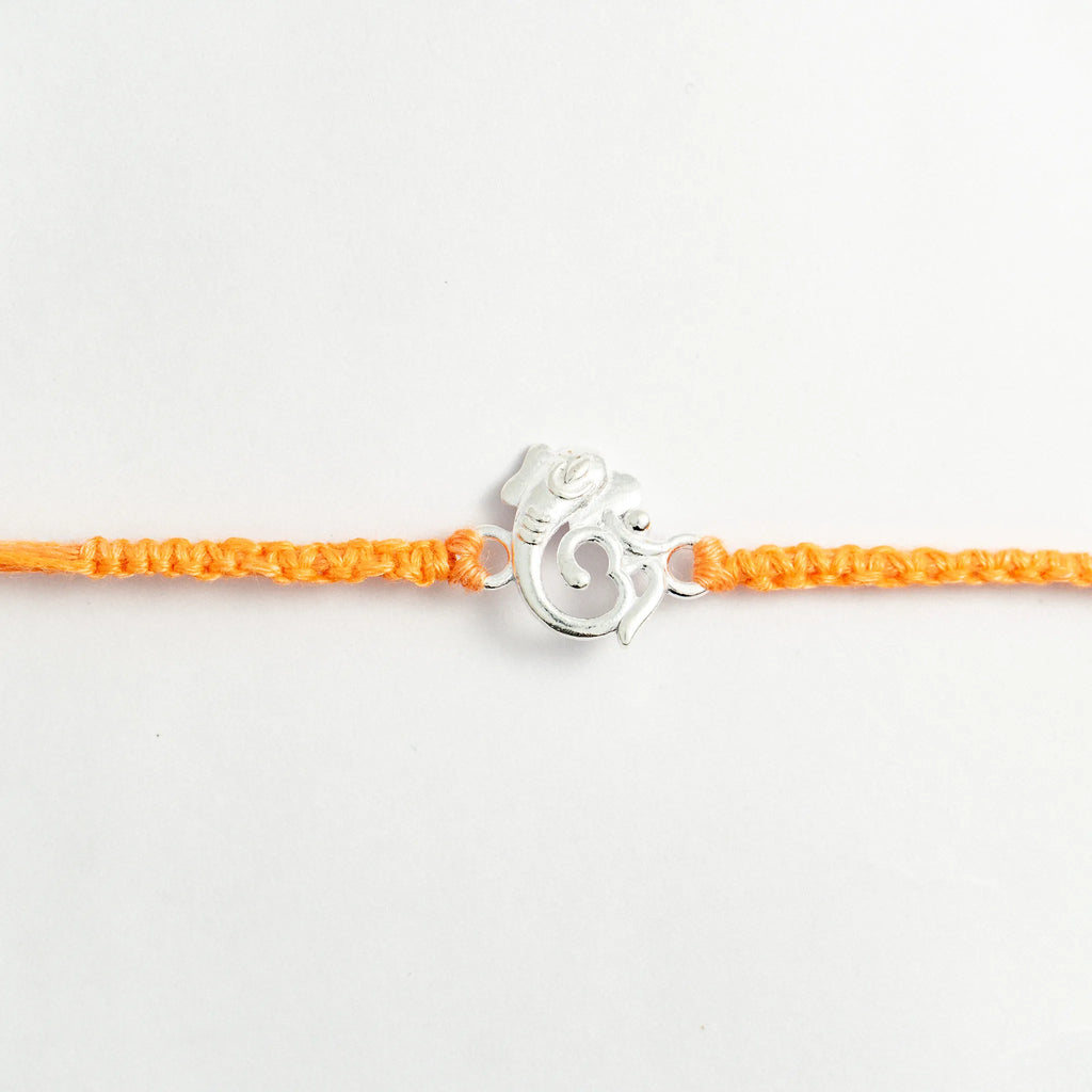 Silver Ganesha Om Rakhi for Brother with Handcrafted Orange Thread
