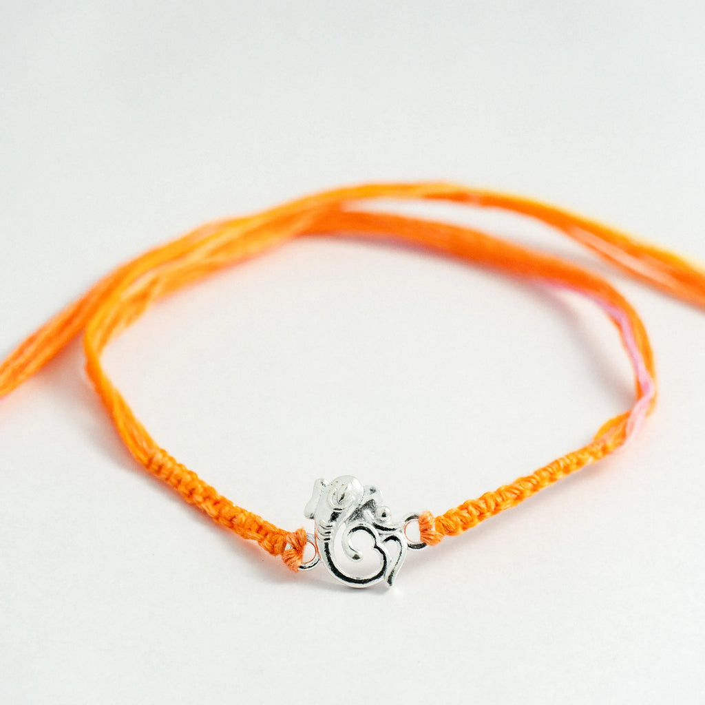 Silver Ganesha Om Rakhi for Brother with Handcrafted Orange Thread