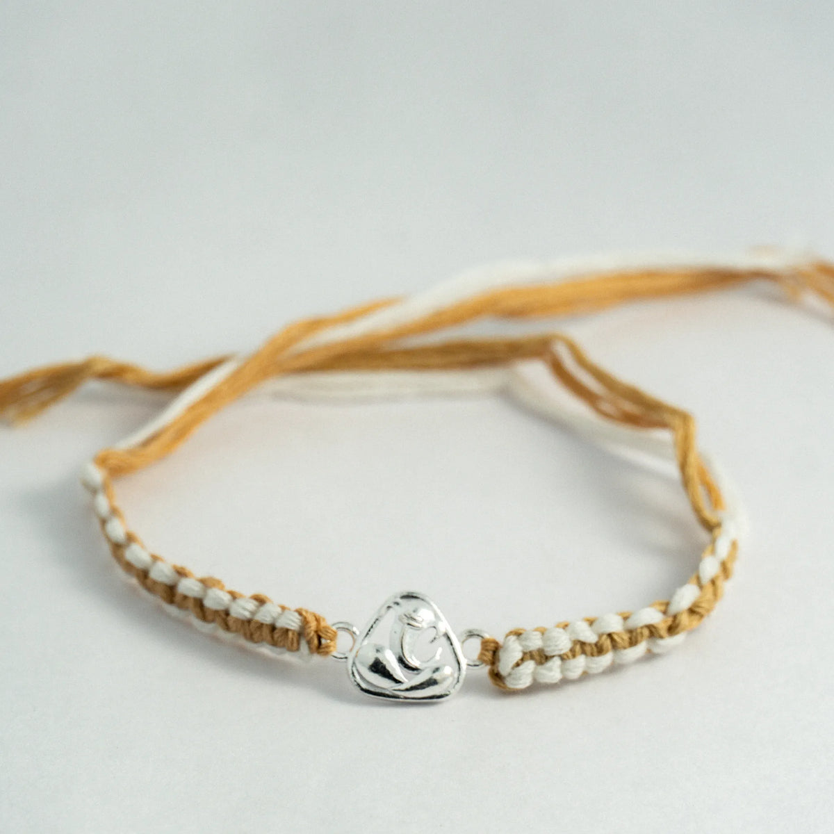 Silver Lord Ganesha Rakhi for Brother with Beige and White Handcrafted Thread